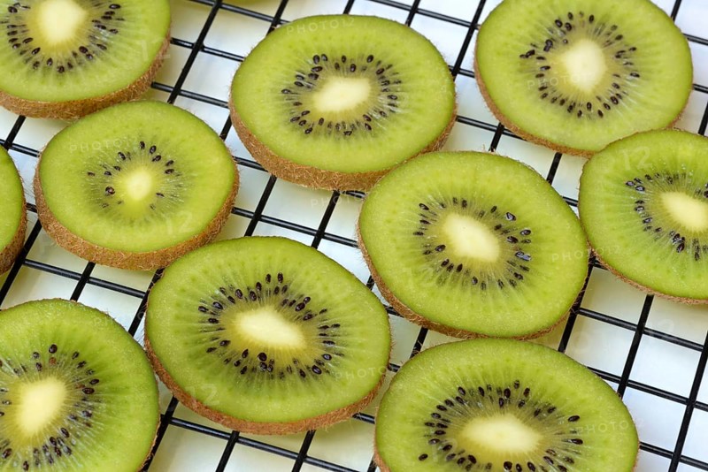 Kiwi slices laid out on a wire rack to dry, Actinidia deliciosa