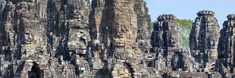 Panoramic image of giant stone-carved faces of the Bodhisattva Lokeshvara, also known as Avalokiteshvara, Bayon Temple, Angkor Thom, UNESCO World Heritage Site, Angkor Wat, Siem Reap, Cambodia, Asia