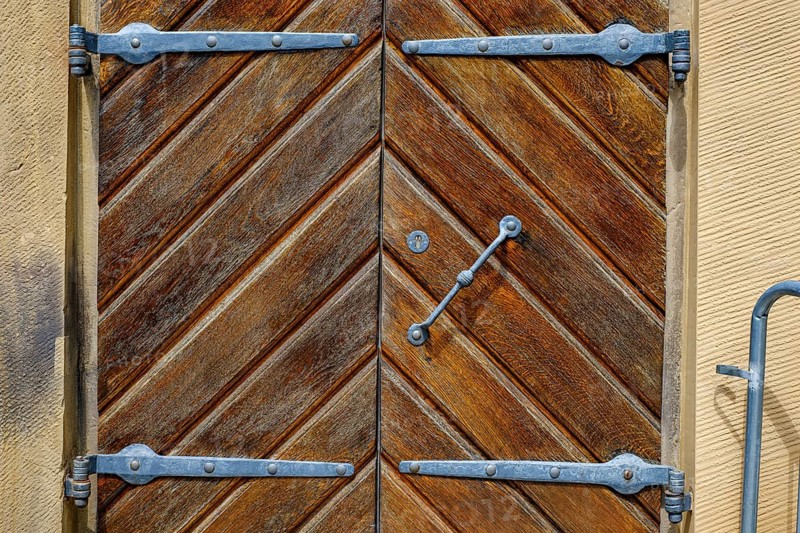 Detail of a historic iron-framed wooden door in the outer wall of the Old Palace in Stuttgart, Baden-Württemberg, Germany, Europe