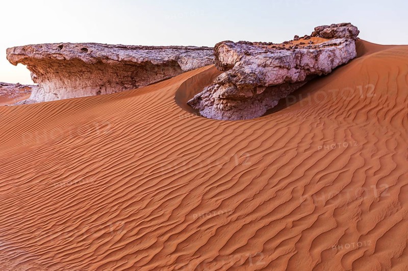Striking cliffs surrounded by windswept sand structures, Huqf stone desert, Arabian Peninsula, Sultanate of Oman