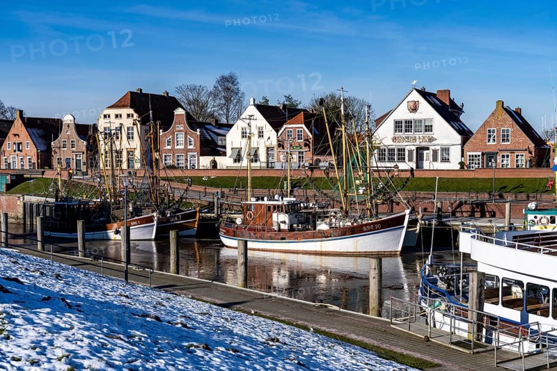 The fishing village of Greetsiel, historic fishing harbour, with the largest shrimp cutter fleet in East Frisia, historic houses, winter, partly frozen, in Lower Saxony, Germany, Europe