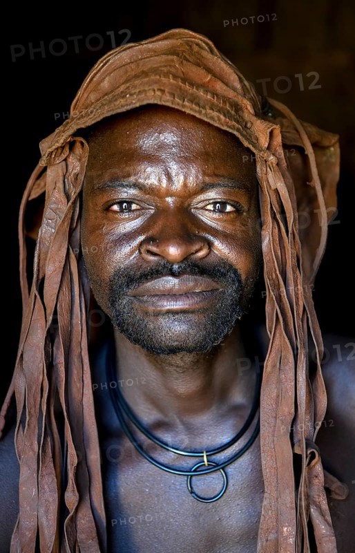 Himba man in his hut, Ohandungu, Kunene region, Kaokoveld, Namibia, Africa