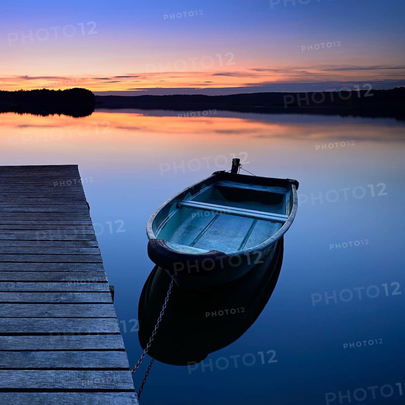 Quiet lake with jetty and rowing boat after sunset at dusk, Großer Lychensee, Lychen, Brandenburg, Germany, Europe