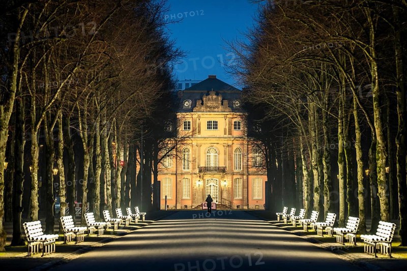 The light benches by artist Stefan Sous in the Hofgarten, entitled UV-A UV-B, 14 completely refurbished exhibits from the 2002 light-grey art exhibition, which now stand and light up as a permanent work of art on Jägerhofallee, LED technology, in the background Jägerhof Palace, home of the Goethe Museum, Düsseldorf, North Rhine-Westphalia, Germany, Europe