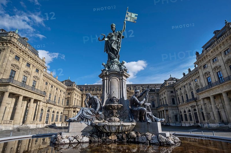 Frankoniabrunnen, neo-baroque, created in 1894, fountain figures and figure of Frankonia with the storm banner, Franconian racing flag in hand, Residenzplatz, Würzburg, Lower Franconia, Bavaria, Germany, Europe