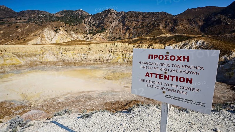 Warning sign in front of volcanic crater in sunny mountainous landscape, volcanism, volcanic island, Caldera Stefanos, Nisyros, Dodecanese, Greek Islands, Greece, Europe