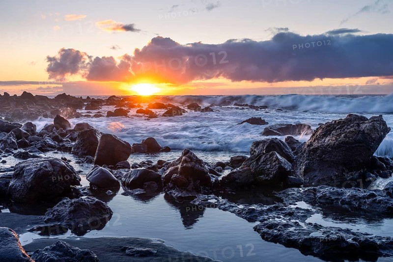 Rocks on the beach of Playa del Inglés. Sunset. Long exposure. Sea and waves. Valle Gran Rey, La Gomera, Canary Islands, Spain, Europe