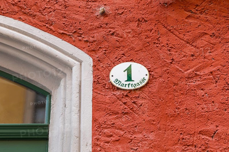 House number Marktgasse 1 on a red façade on the market square in Meißen, Saxony, Germany, Europe
