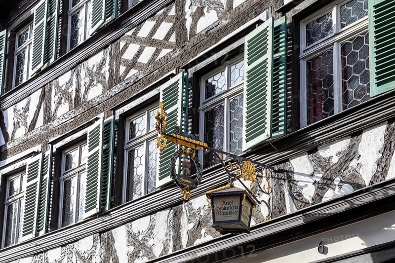 Façade with half-timbering and shutters and historic nose sign, famous Schlenkerla brewery, Bamberg, Bavaria, Germany, Europe