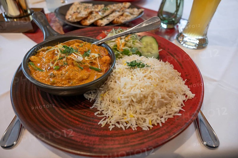 Mango Chicken, chicken in fresh mango-saffron cashew nut almond sauce and served with rice in an Indian restaurant, Bavaria, Germany, Europe