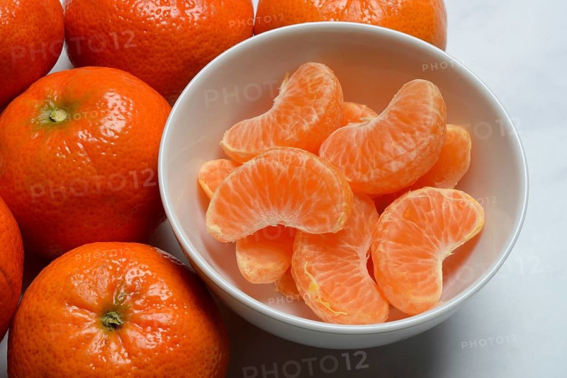 Clementines and clementine pieces in peel, clementine