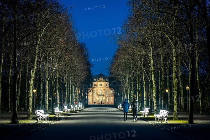 The light benches by artist Stefan Sous in the Hofgarten, entitled UV-A UV-B, 14 completely refurbished exhibits from the 2002 light-grey art exhibition, which now stand and light up as a permanent work of art on Jägerhofallee, LED technology, in the background Jägerhof Palace, home of the Goethe Museum, Düsseldorf, North Rhine-Westphalia, Germany, Europe