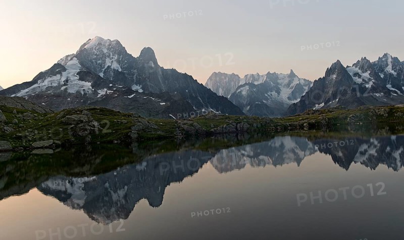 Dusk at the Lacs des Chéserys mountain lake in the Aiguilles Rouges nature reserve, with the Aiguille Verte, Aiguille du Dru and Grandes Jorasses peaks behind, Chamonix, Haute Savoie, France, Europe