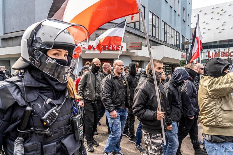 The neo-Nazi group Jung und Stark, JS, demonstrates in the city centre of Essen, demanding the remigration of foreigners, chanting Deutschland den Deutschen Ausländer raus, approx. 150 ultra right-wingers, dressed in black and wearing typical scene clothing, several groups demonstrate against the Nazi march, Essen, North Rhine-Westphalia, Germany, Europe