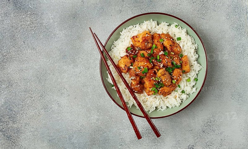 Fried chicken teriyaki with rice, green onion and sesame, homemade, no people