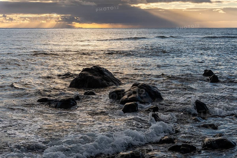 Rocks on the beach of Playa del Inglés. Sunset. Sea and waves. Valle Gran Rey, La Gomera, Canary Islands, Spain, Europe