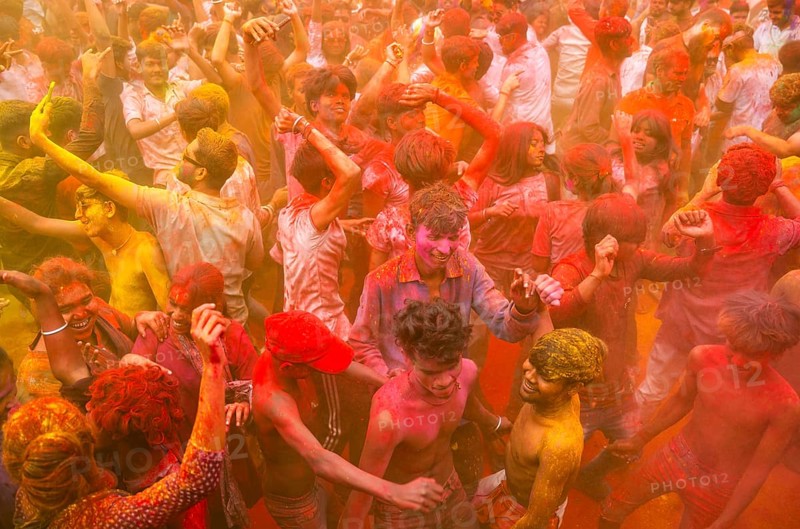 Revellers smear with Gulal or coloured powder and dance to play Holi, the Hindu spring festival of colours, on March 14, 2025 in Guwahati, India, Asia