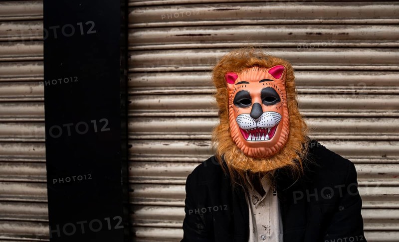A person wears a mask to play Holi, the Hindu spring festival of colours, on March 14, 2025 in Guwahati, India, Asia
