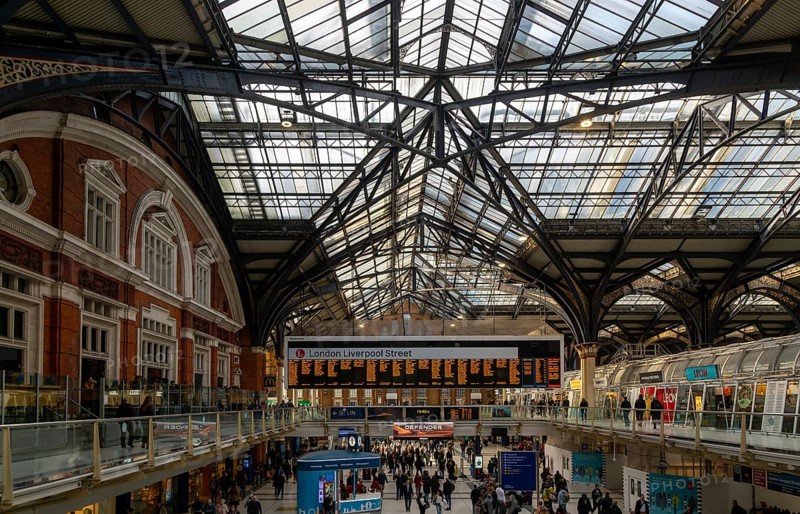 Details roof engineering at Liverpool Street railway station, London, England, UK Concourse busy with passengers