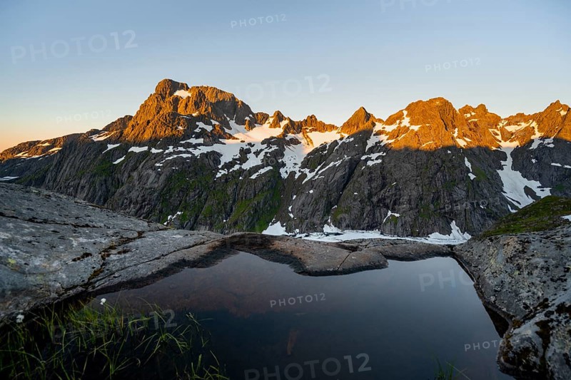 Rocky mountain peaks, small pond in moorland at Trollfjord Hytta, mountain landscape with alpenglow at sunrise, at Trollfjord, Lofoten and Vesterålen, Nordland, Norway, Europe