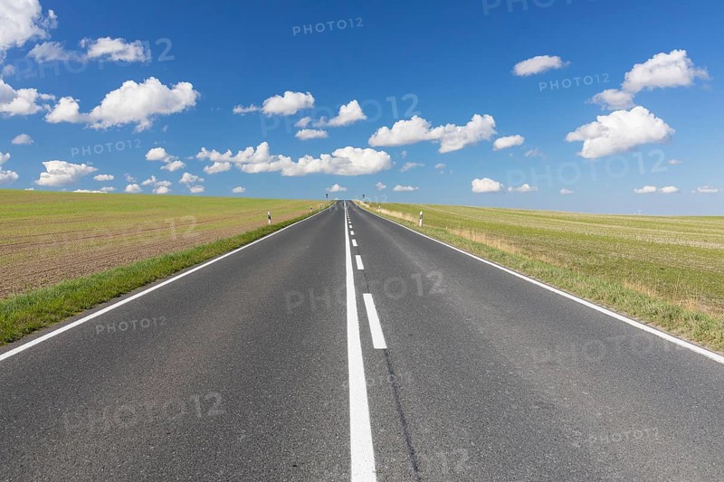 Straight country road, B173 between Dresden and Freiberg, without cars, blue sky with fair weather clouds, Wilsdruff, Saxony, Germany, Europe
