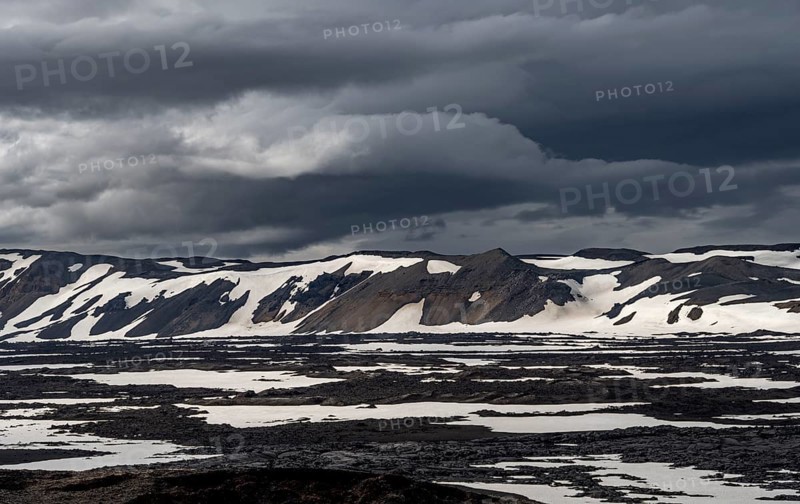 Snow-covered volcanic landscape with volcanic sand and petrified lava, crater of Askja volcano, Icelandic highlands, Iceland, Europe