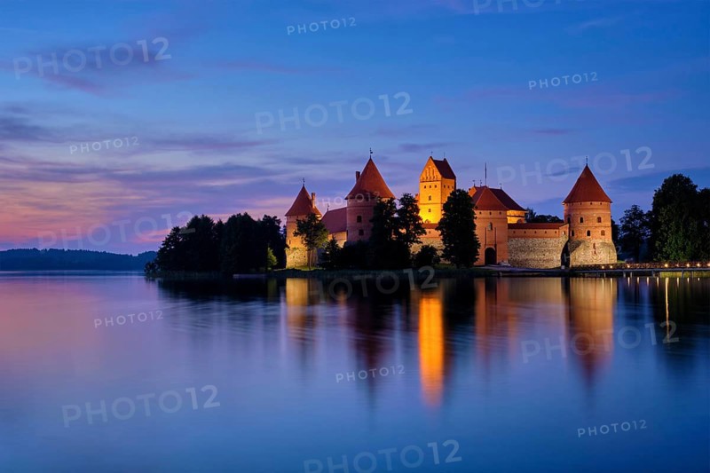 Night view of Trakai Island Castle in lake Galve illuminated in the evening, Lithuania, Europe