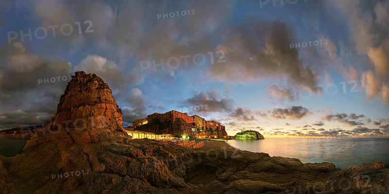 Panorama on the beach Lido Le Roccette Club Tropea with the old town of Tropea situated on rocks of sandstone and the medieval church Santuario di Santa Maria dell Isola at sunset and luminous cloudy sky, Tropea, Vibo Valentia, Calabria, Southern Italy, Italy, Europe