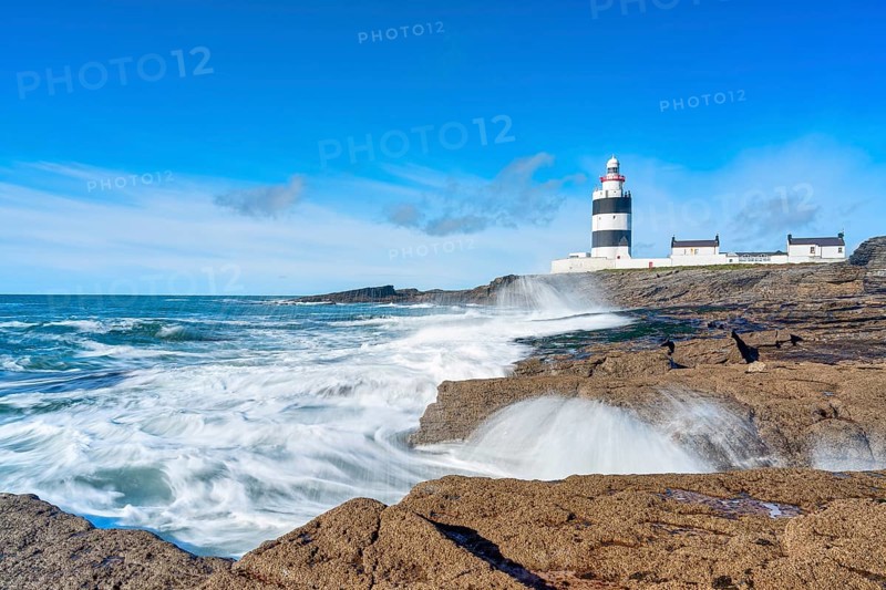 Hook Head lighthouse, blue sky and spray, Wexford, Ireland, Europe