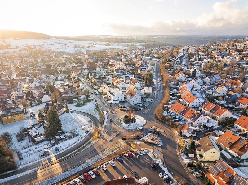 Winter city view with snow-covered streets and a roundabout, Calw- Stammheim, Black Forest, Germany, Europe