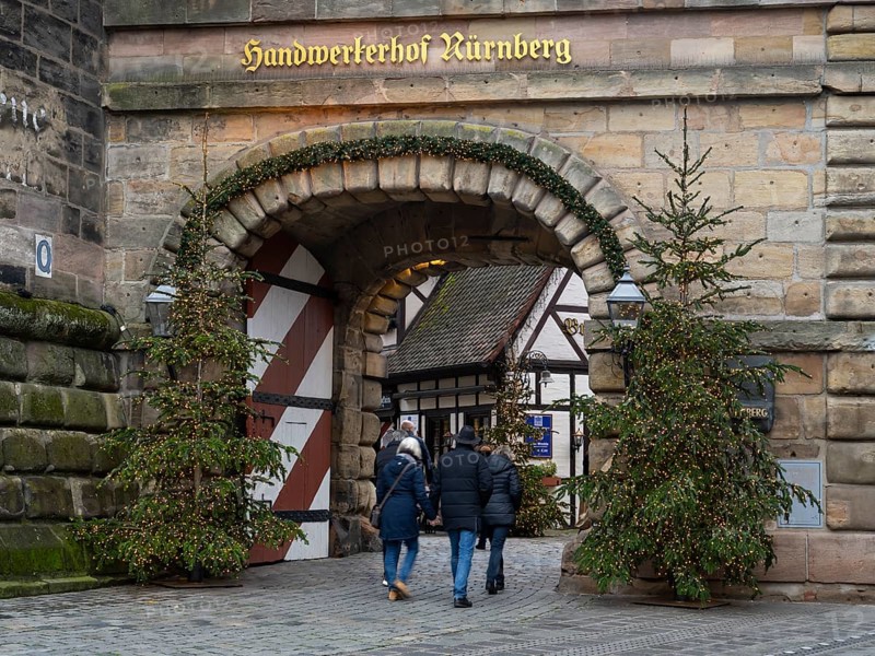 People walking through the Königstor, Christmas trees with fairy lights, Handwerkerhof, Nuremberg, Middle Franconia, Franconia, Bavaria, Germany, Europe
