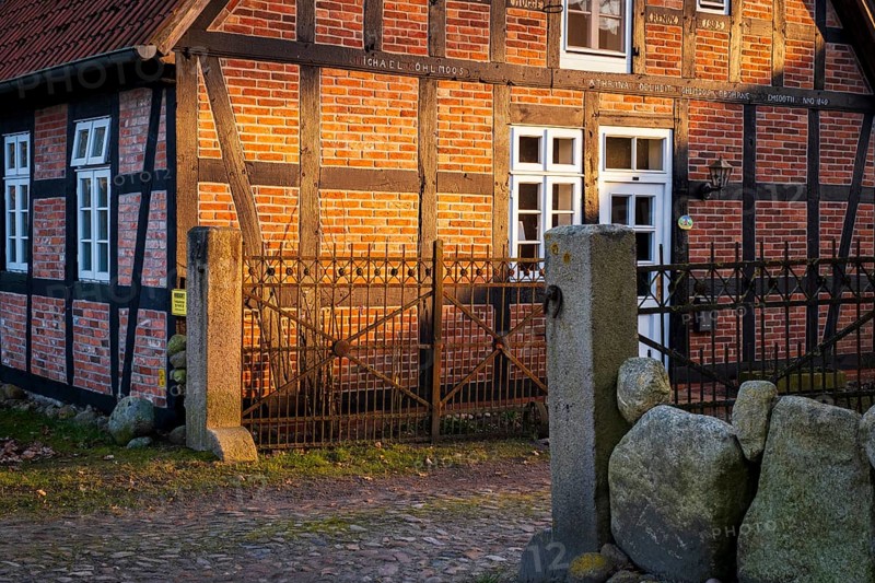 Evening light shines on a driveway and the façade of a half-timbered house, Otersen, Kirchlinteln, Verden, Aller Leine Valley, Lower Saxony, Germany, Europe