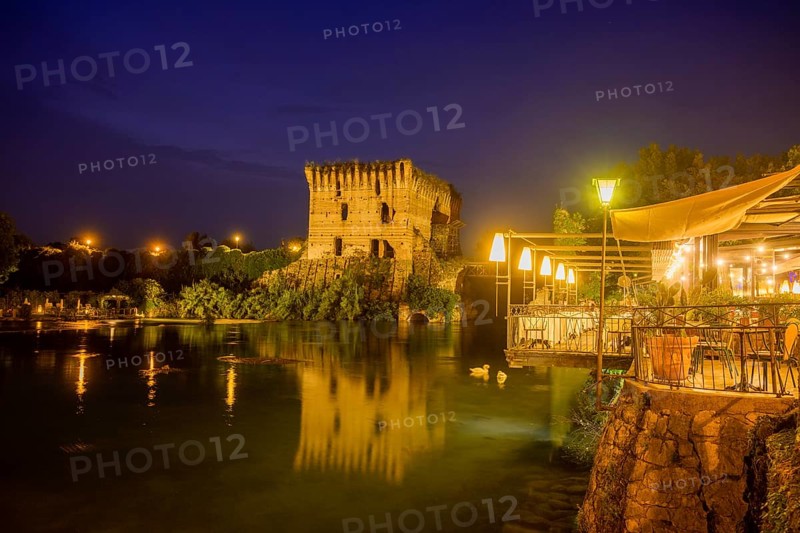 Night shot of restaurant on the Mincio river and Visconti bridge from 1395 in the background, Borghetto, Valeggio sul Mincio, province of Verona, Italy, Europe