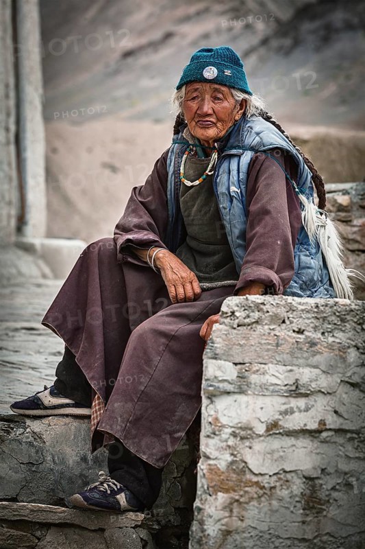 LAMAYURU, INDIA, SEPTEMBER 10, 2011: Old tibetan woman sitting near Lamayuru gompa in Ladakh, India, Asia