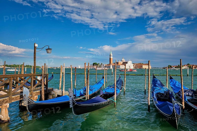 Gondolas and in lagoon of Venice by Saint Mark (San Marco) square with San Giorgio di Maggiore church in background in Venice, Italy, Europe