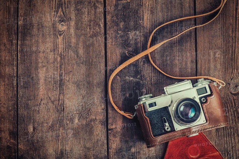 Photography concept background, old retro vintage camera on grunge wooden texture