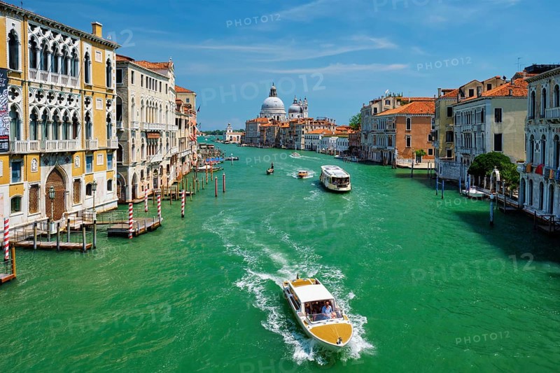 VENICE, ITALY, JULY 19, 2019: View of Venice Grand Canal with boats and Santa Maria della Salute church in the day from Ponte dell'Accademia bridge. Venice, Italy, Europe