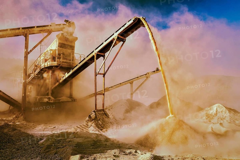 Vintage retro effect filtered hipster style image of Industrial background, crusher rock stone crushing machine at open pit mining and processing plant for crushed stone, sand and gravel