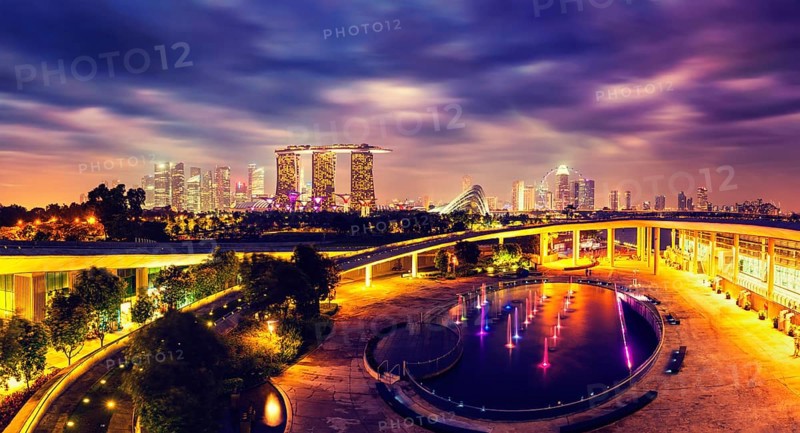 Singapore travel tourism concept, vintage retro effect filtered hipster style image of panorama of Singapore skyline illumintaed in the evening twilight