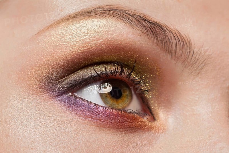 Macro image of human woman eye with make up