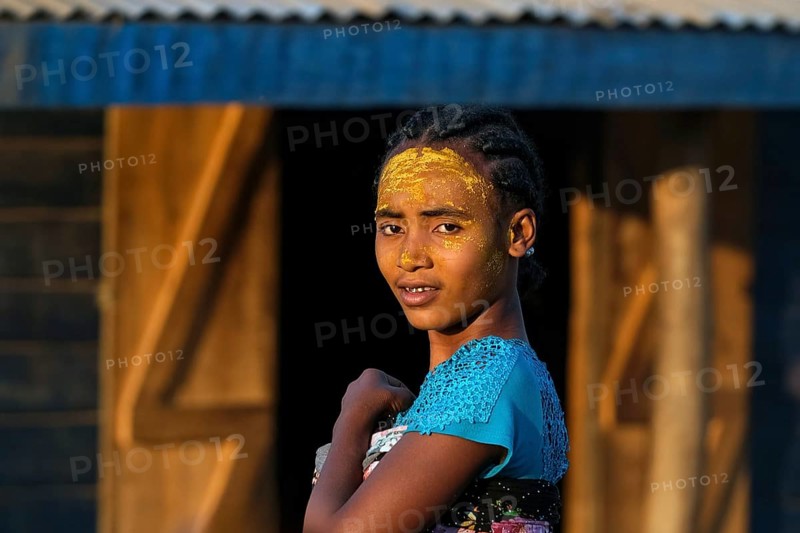Malagasy girl with sun protection mask made from Musiro root at Begidro near Ankiliroroka, Belo sur Tsiribihina, Menabe, Central Highlands, Madagascar, Africa