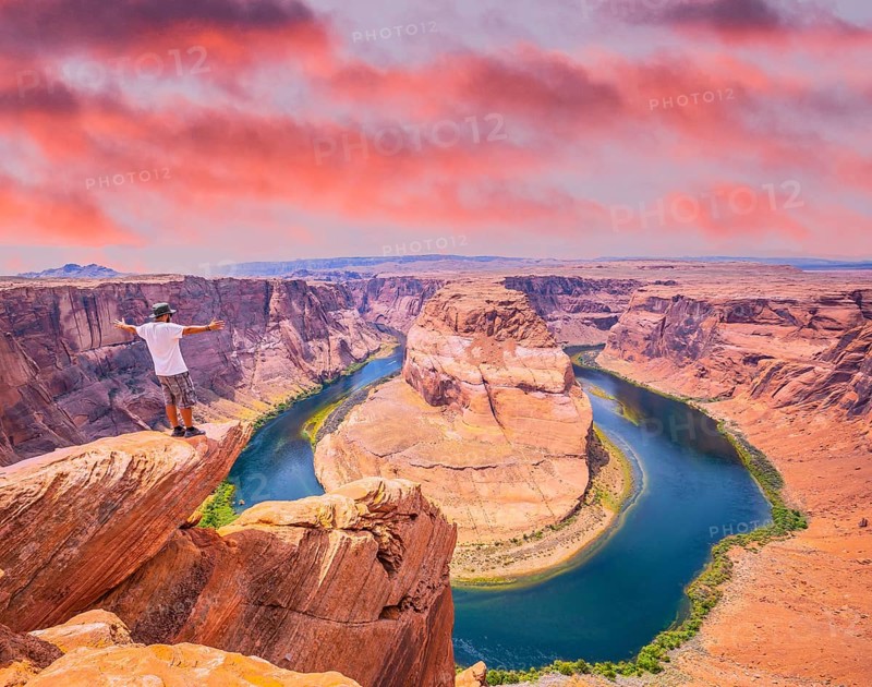 A young man with white shirt and green hat in Horseshoe Bend, Arizona. United States