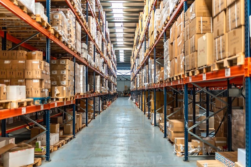 Interior view of an aisle of a distribution warehouse full of packages and no people