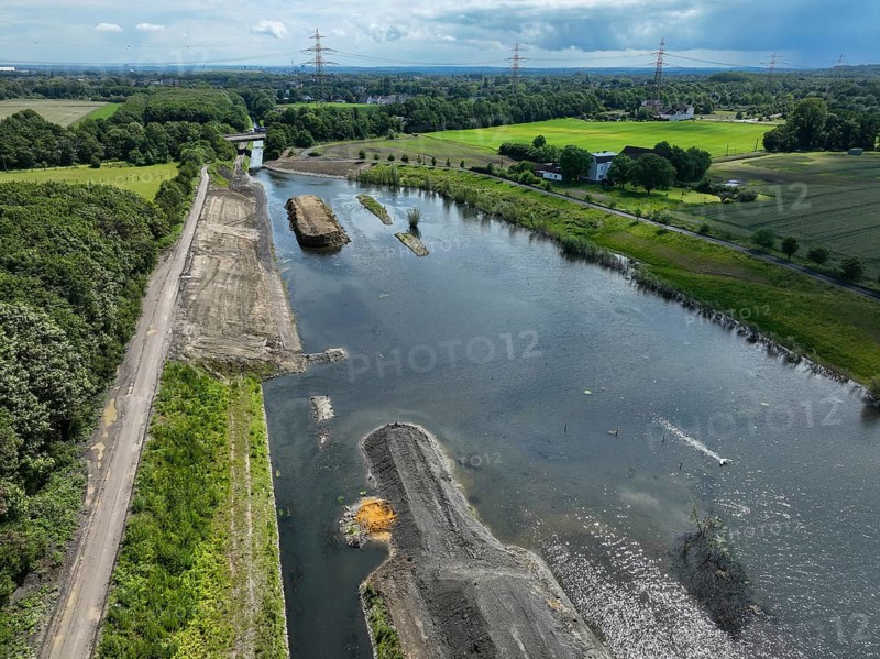 Dortmund / Castrop-Rauxel, North Rhine-Westphalia, Germany, river renaturalisation, renaturation of the Emscher, flood retention basin HRB Mengede. A new floodplain landscape is being created at the Emscher-Auen farm, expanding the area for flood protection during heavy rainfall and for biodiversity. The Emscher, which is currently straightened, will be given curves again and can meander through its new floodplain. Following the construction of a parallel sewer, the Emscher has been completely free of wastewater since 2022. The river was previously an open, above-ground combined sewer with rainwater and wastewater. The A45 motorway in the background, Europe