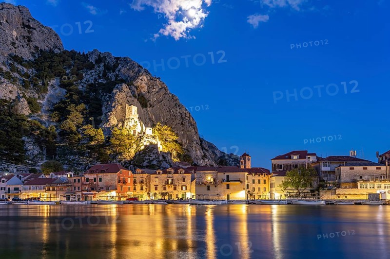 The old town centre of Omis on the river Cetina with the ruins of the Mirabella fortress or Peovica at dusk, Croatia, Europe