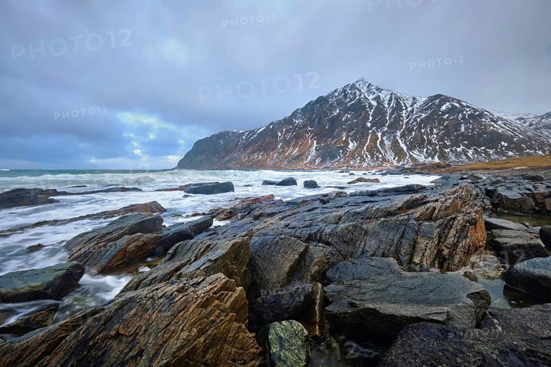 Rocky coast of fjord of Norwegian sea in winter. Lofoten islands, Norway, Europe