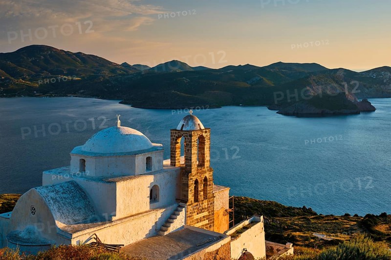Traditional whitewashed Greek Orthodox church in Plaka village on Milos island on sunset. Milos island, Greece, Europe