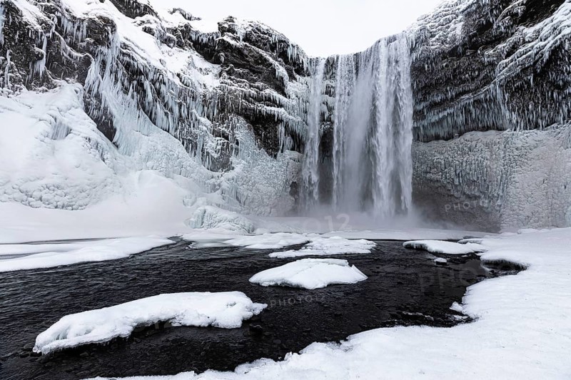 Skogafoss waterfall, snowy and icy rock face, Sudurland, Iceland, Europe