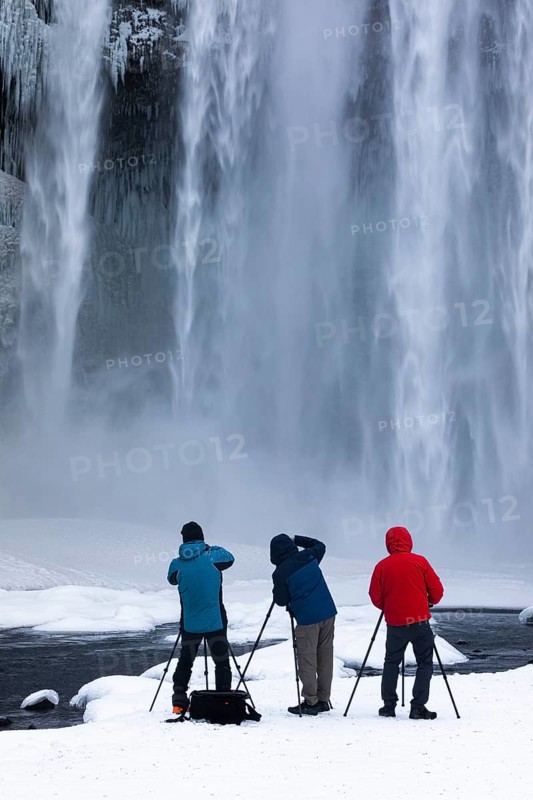 Photographers at Skogafoss waterfall, winter landscape, Sudurland, Iceland, Europe