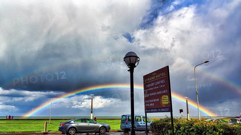 View of the coast road from the Strand Hotel, double rainbow in the cloudy sky, Bray, Wicklow, Ireland, Europe